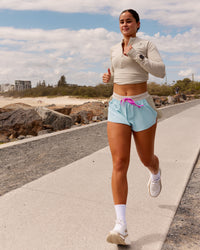 Woman wearing Accelerate 3" Mid-Rise Running Short - Taupe Ash-Glacial Blue | Model:Kiara | Size:S | Thumbnail Index: 3
