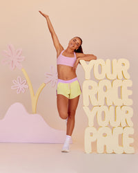 Woman wearing Accelerate 3" Mid-Rise Running Short - Marshmallow-Lemon | Model:Grace | Size:S | Thumbnail Index: 0