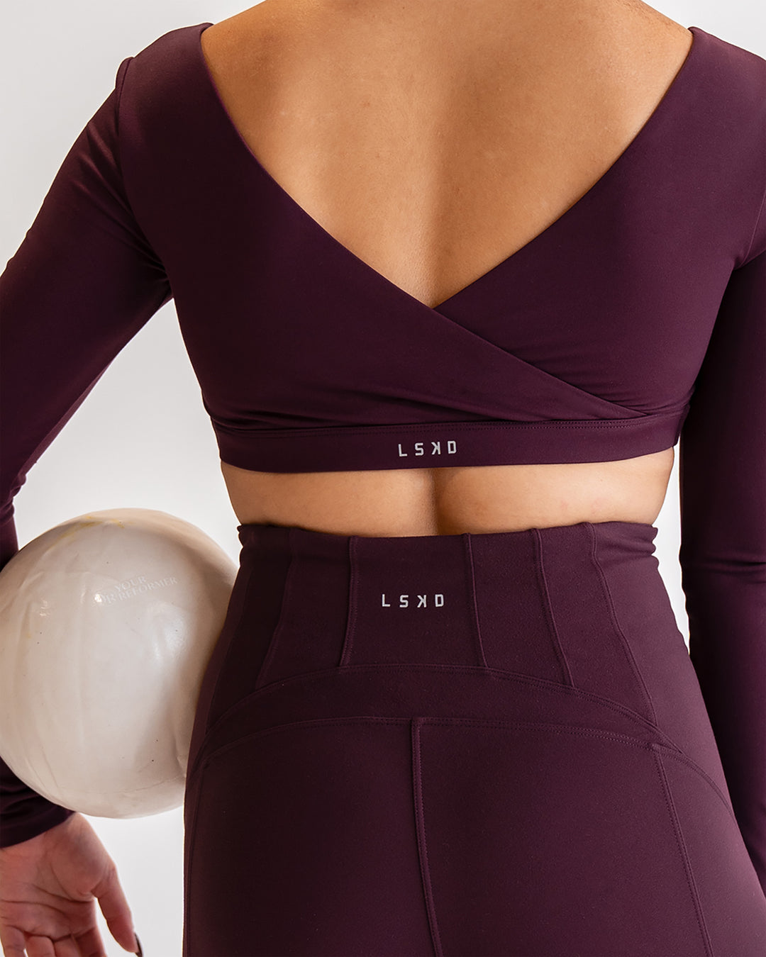 Woman wearing Aria Long Sleeve Sports Bra - Cherry Lacquer | Model:Sarah | Size:S - view 2