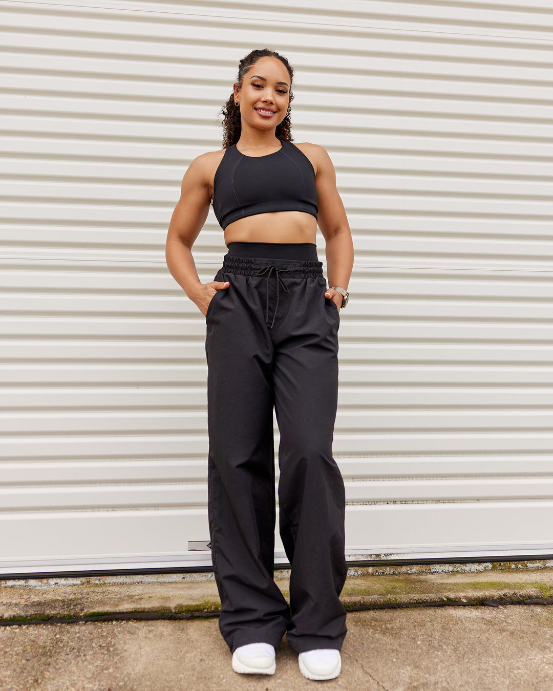 Woman wearing Ascent Sports Bra - Black | Model:Tarnie | Size:S - view 3