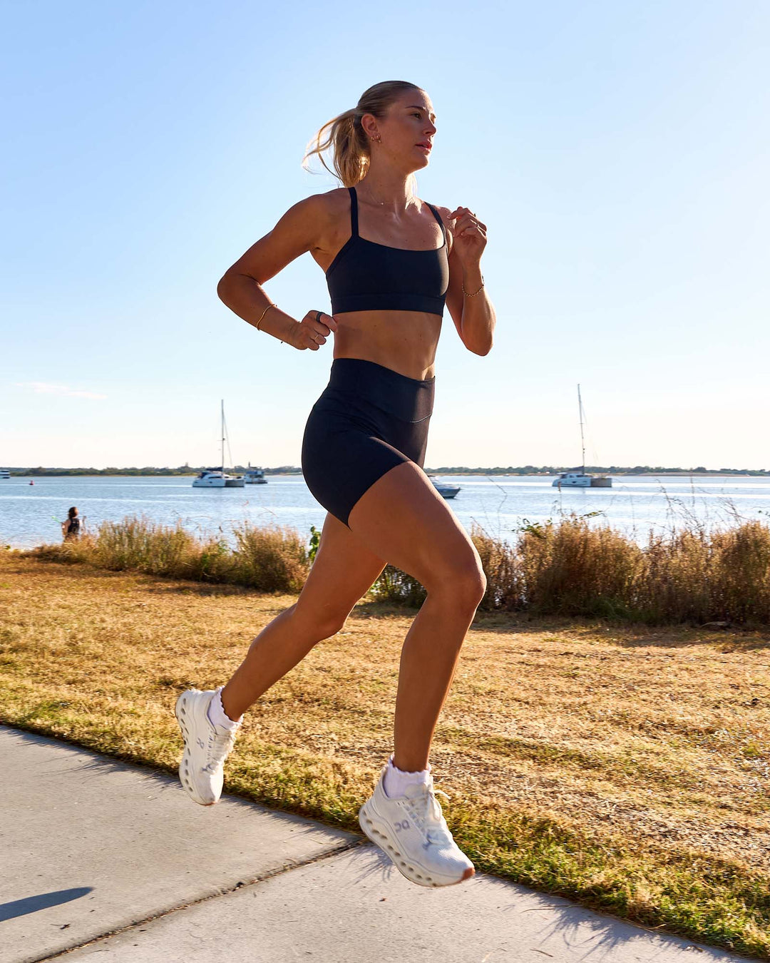 Woman wearing Elite Run High-Rise 5" Short Pockets - Black | Model:Emelia | Size:S - view 7