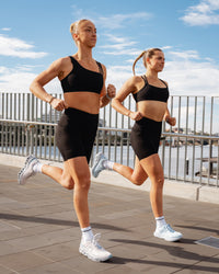 Duo wearing Elite Run High-Rise 7" Short Pockets - Black | Model:Both | Size:S | Thumbnail Index: 1