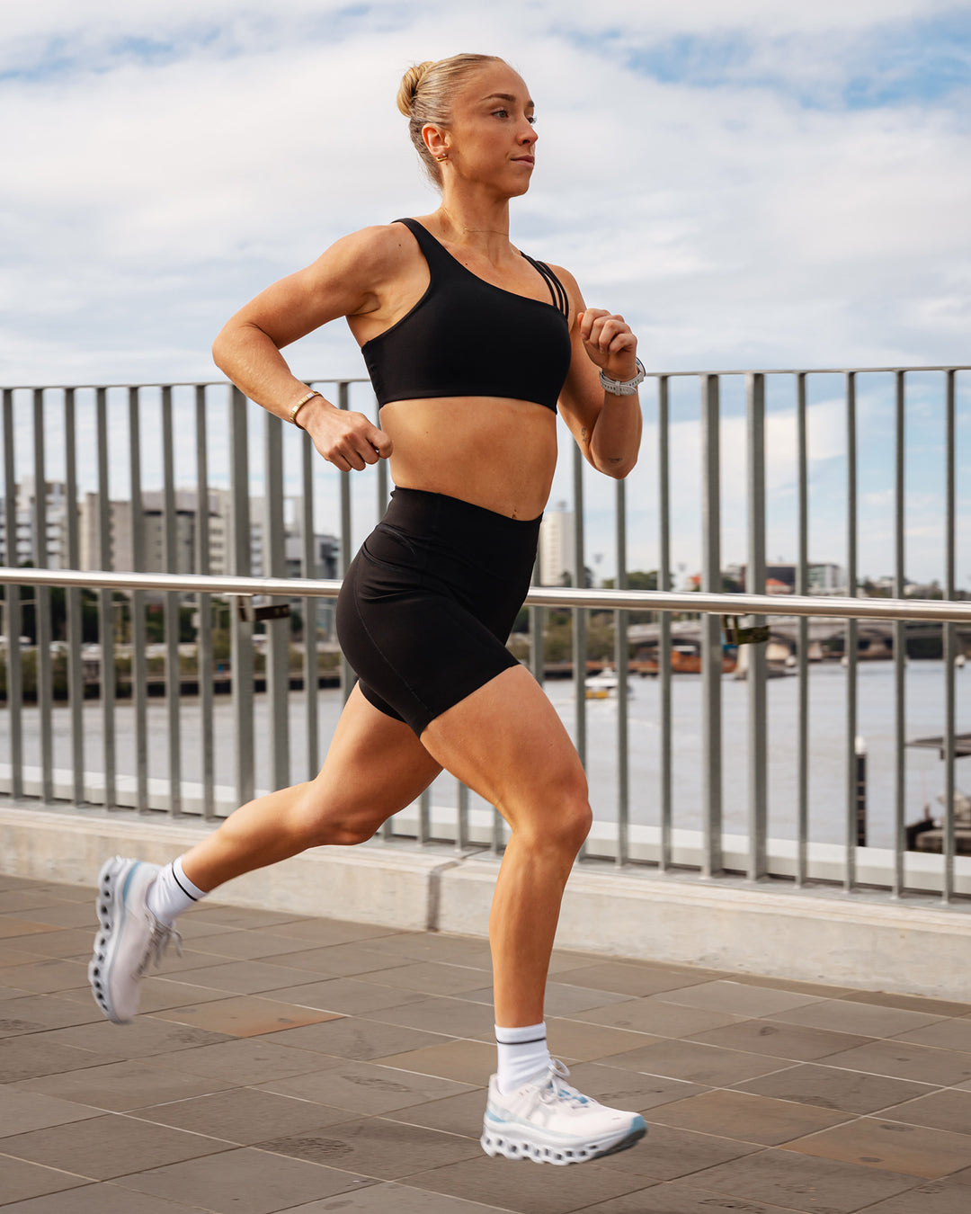 Woman wearing Elite Run High-Rise 7" Short Pockets - Black | Model:Bronte | Size:S - view 7