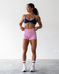 Woman wearing Enhance Ultra High-Rise 4" Short - Pink Frosting | Model:Emily | Size:S | Thumbnail Index: 0