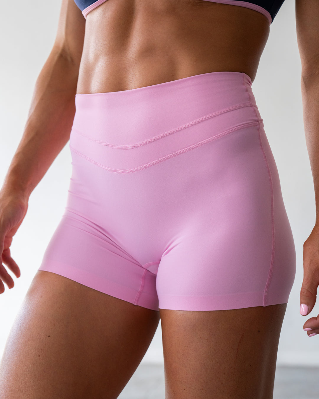 Woman wearing Enhance Ultra High-Rise 4" Short - Pink Frosting | Model:Emily | Size:S - view 2