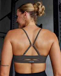 Woman wearing Essence Sports Bra - Dark Storm | Model:Shae | Size:S | Thumbnail Index: 1