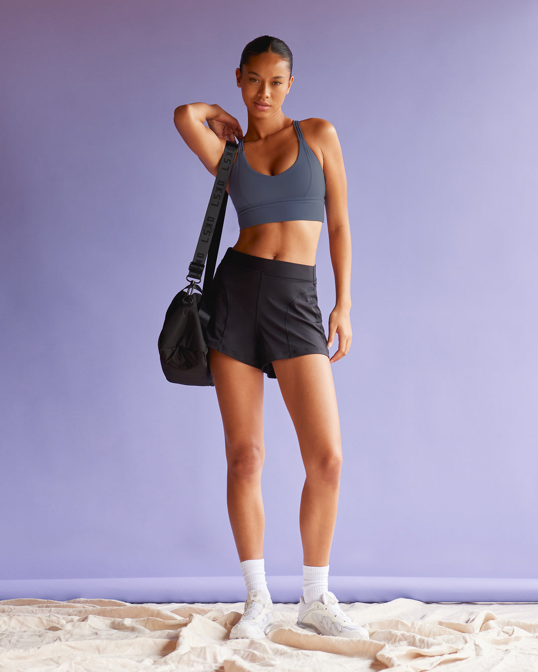 Woman wearing Flash Longline Sports Bra - Night Shadow | Model:Tali | Size:S - view 3