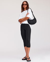 Woman wearing Fusion Ultra High-Rise 3/4 Legging Pockets - Black | Model:Dakota | Size:S | Thumbnail Index: 3