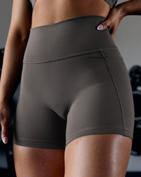 Woman wearing Fusion Ultra High-Rise 4" Short Pockets - Dark Storm | Model:Ayla | Size:S | Thumbnail Index: 0