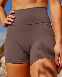 Woman wearing Fusion Ultra High-Rise 4" Short Pockets - Peppercorn | Set:true | Angle:closeup | Model:Rica | Size:S | Thumbnail Index: 0