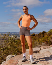 Woman wearing Fusion Ultra High-Rise 4" Short Pockets - Peppercorn | Model:Rica | Size:S | Thumbnail Index: 3