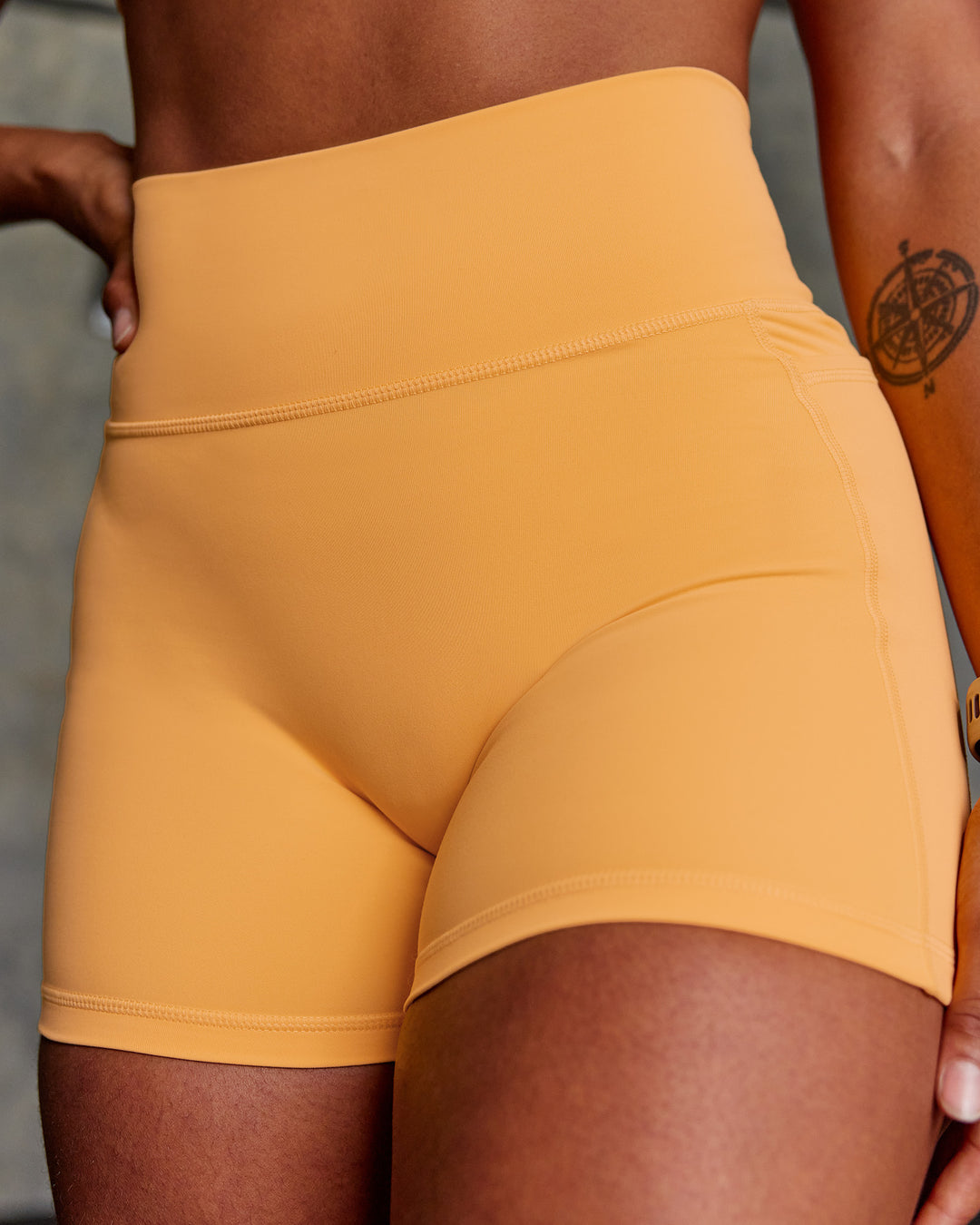 Woman wearing Fusion Ultra High-Rise 4" Short Pockets - Warm Apricot | Model:Janet | Size:S - view 1