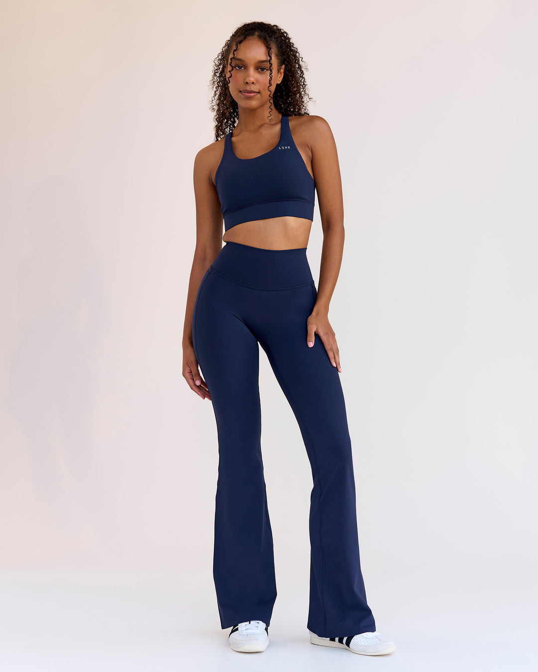 Woman wearing Fusion V-Contour High-Rise Flared Legging Pockets - Future Navy | Model:Jordan | Size:S - view 8