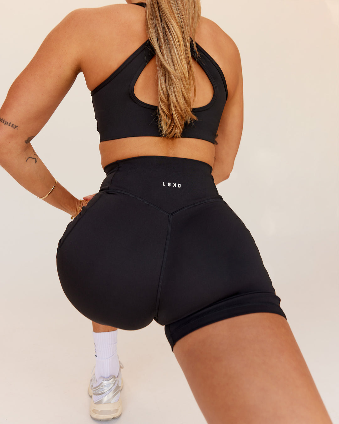 Woman wearing Fusion V-Contour Ultra High-Rise 4” Short Pockets - Black | Model:Shae | Size:S - view 4