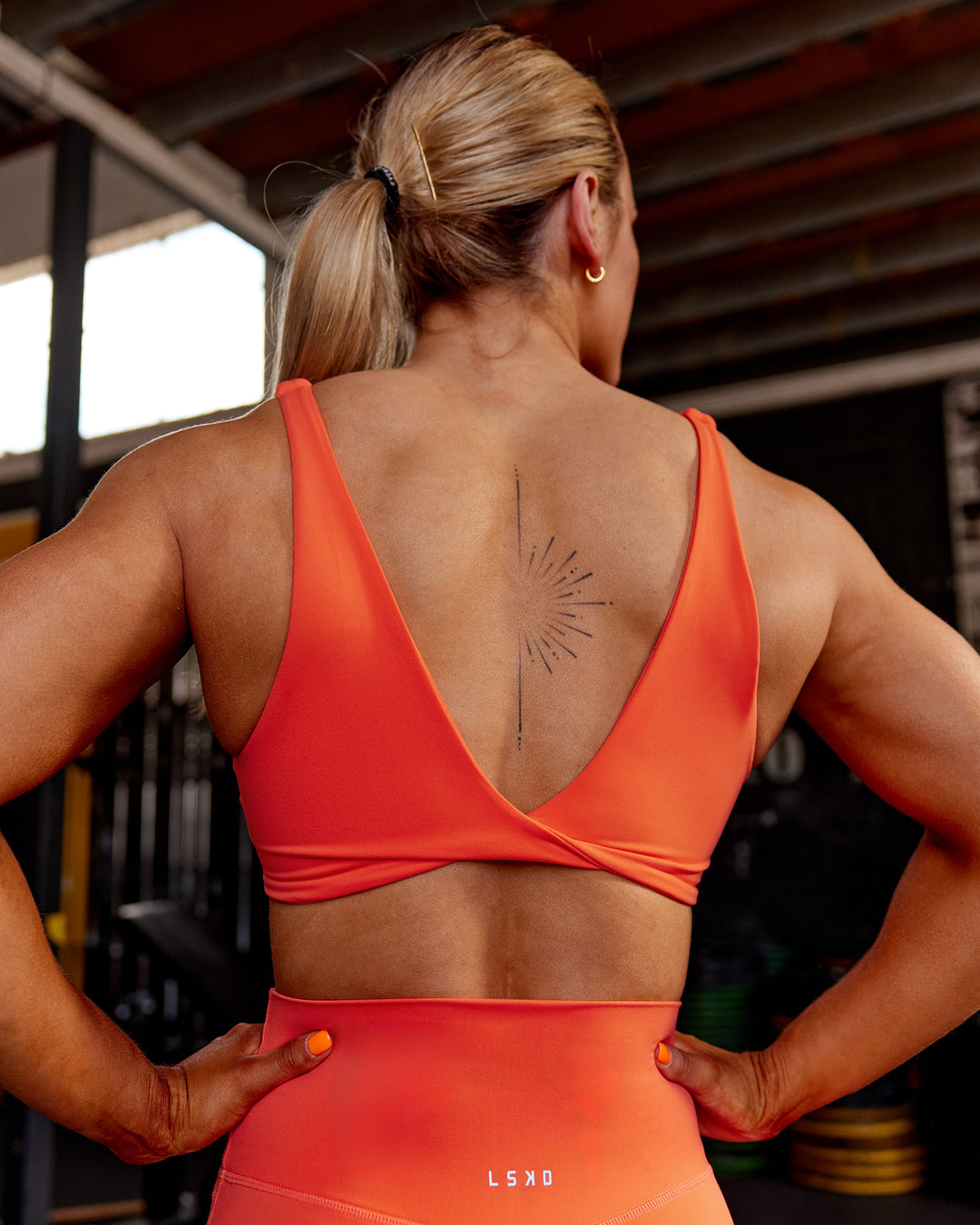 Woman wearing Impulse Reversible Sports Bra - Ultra Orange | Model:Georgia | Size:S - view 3
