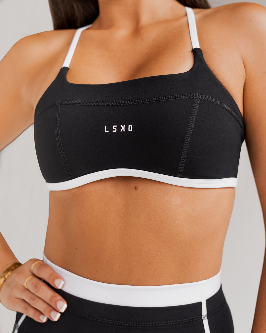 Woman wearing Liberate Sports Bra - Black-White | Model:Jordi | Size:S - view 3