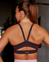 Woman wearing Momentum Sports Bra - Midnight Plum | Model:Roisin | Size:S | Thumbnail Index: 1