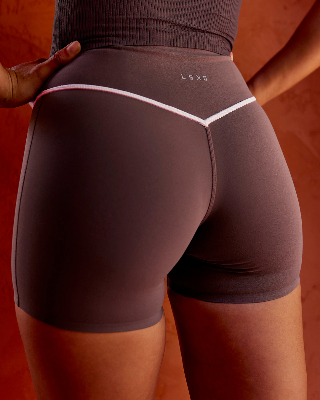 Woman wearing Pinnacle High-Rise 4" Short - Cocoa Powder-Off White | Model:Shae | Size:S - view 2
