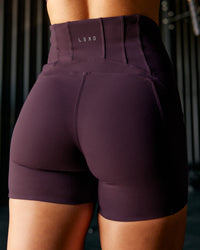 Woman wearing Progression Ultra High-Rise 4" Short - Midnight Plum | Model:Te | Size:S | Thumbnail Index: 1