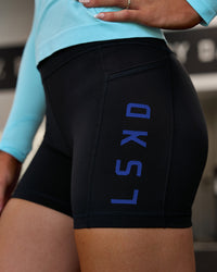 Woman wearing Rep Ultra High-Rise 4" Short Pockets - Black-Electric Indigo | Model:Emelia | Size:S | Thumbnail Index: 0