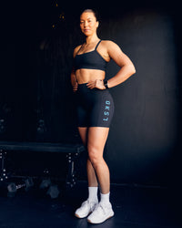 Woman wearing Rep Ultra High-Rise 6" Short Pockets - Black-Blue Atoll | Model:Bailey | Size:S | Thumbnail Index: 1