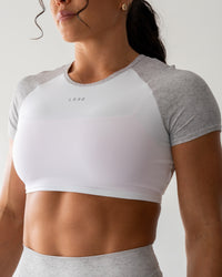 Woman wearing Run With It Ultra Cropped Tee - White-Grey Marl | Model:Emily | Size:S | Thumbnail Index: 0