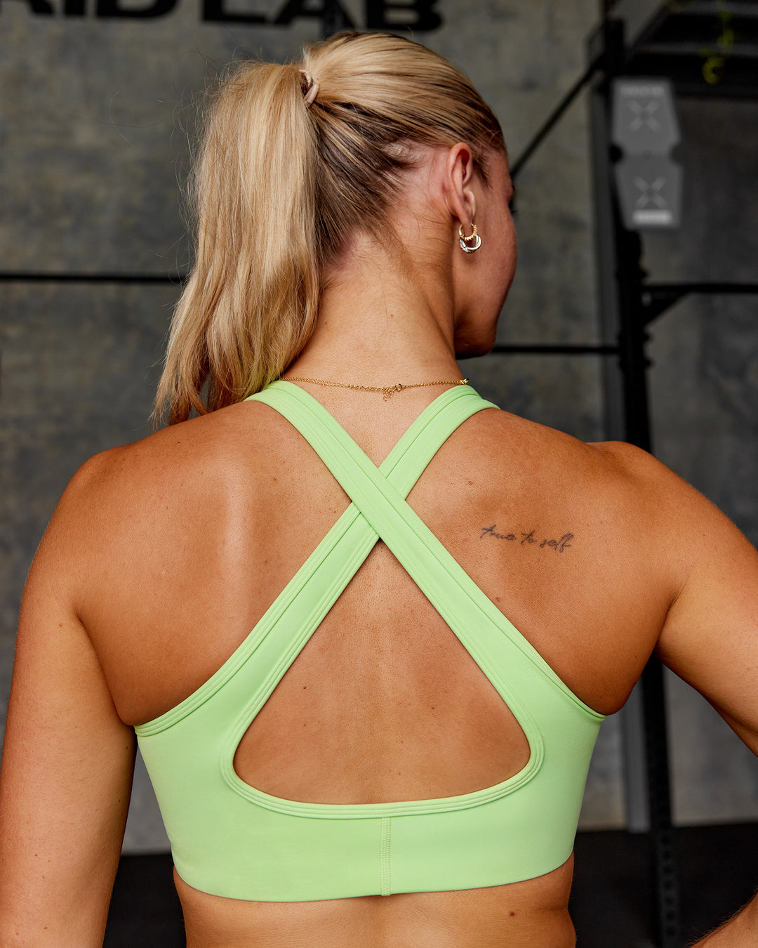 Woman wearing Stamina Sports Bra - Solar Lime | Model:Hannah | Size:S - view 2