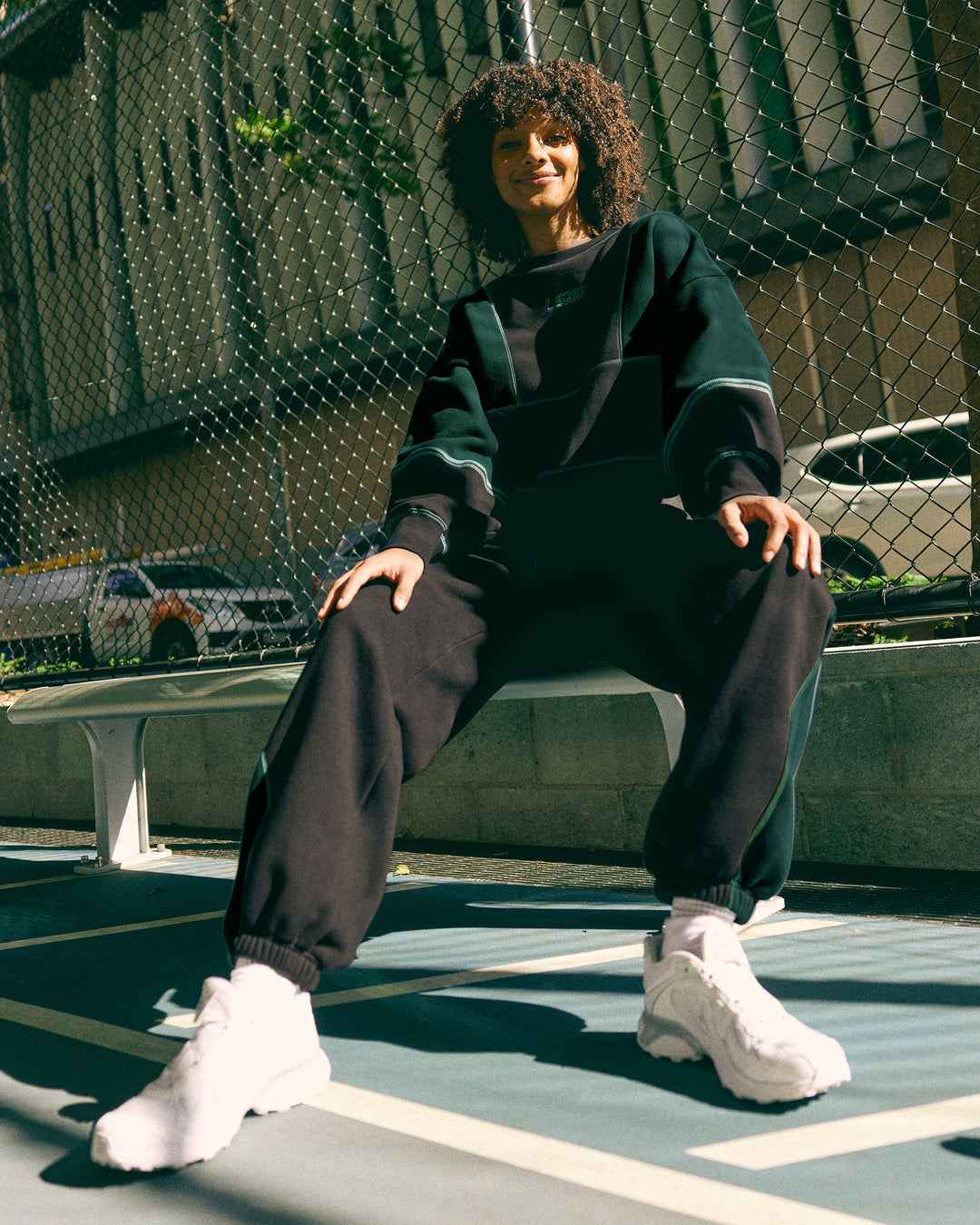 Woman wearing Stitch Up Oversized Fleece Sweater - Black-Dark Moss | Model:Tomi | Size:S - view 3