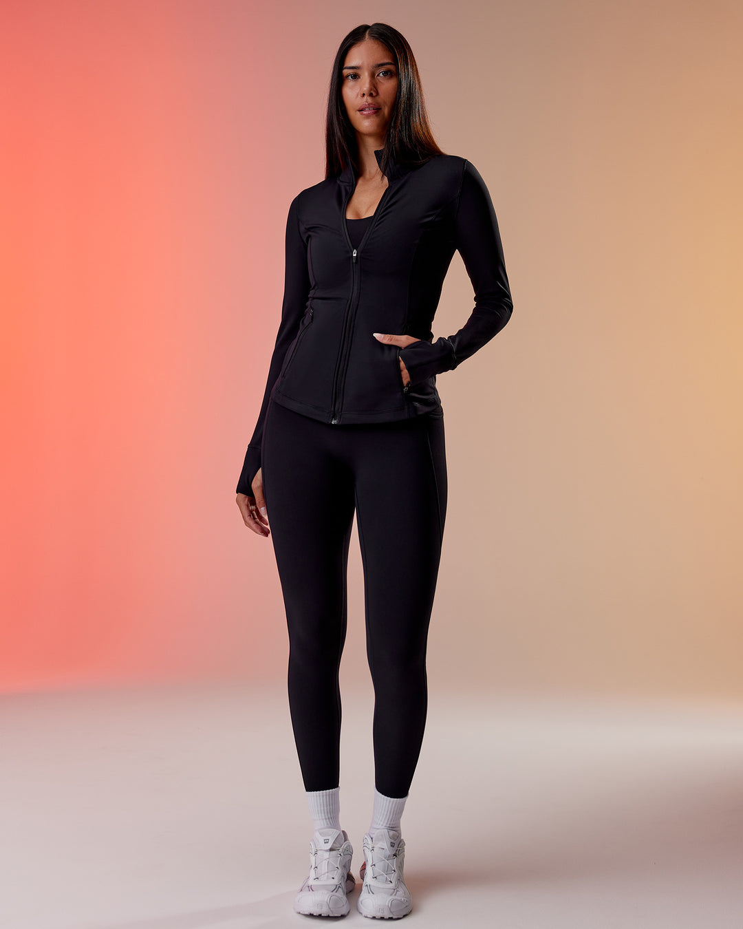 Woman wearing Stride Thermal Zip Through Jacket - Black | Model:Rhiley | Size:S - view 1