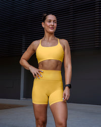 Woman wearing Twist Sports Bra in Banana Cream | Size:S | Thumbnail Index: 2