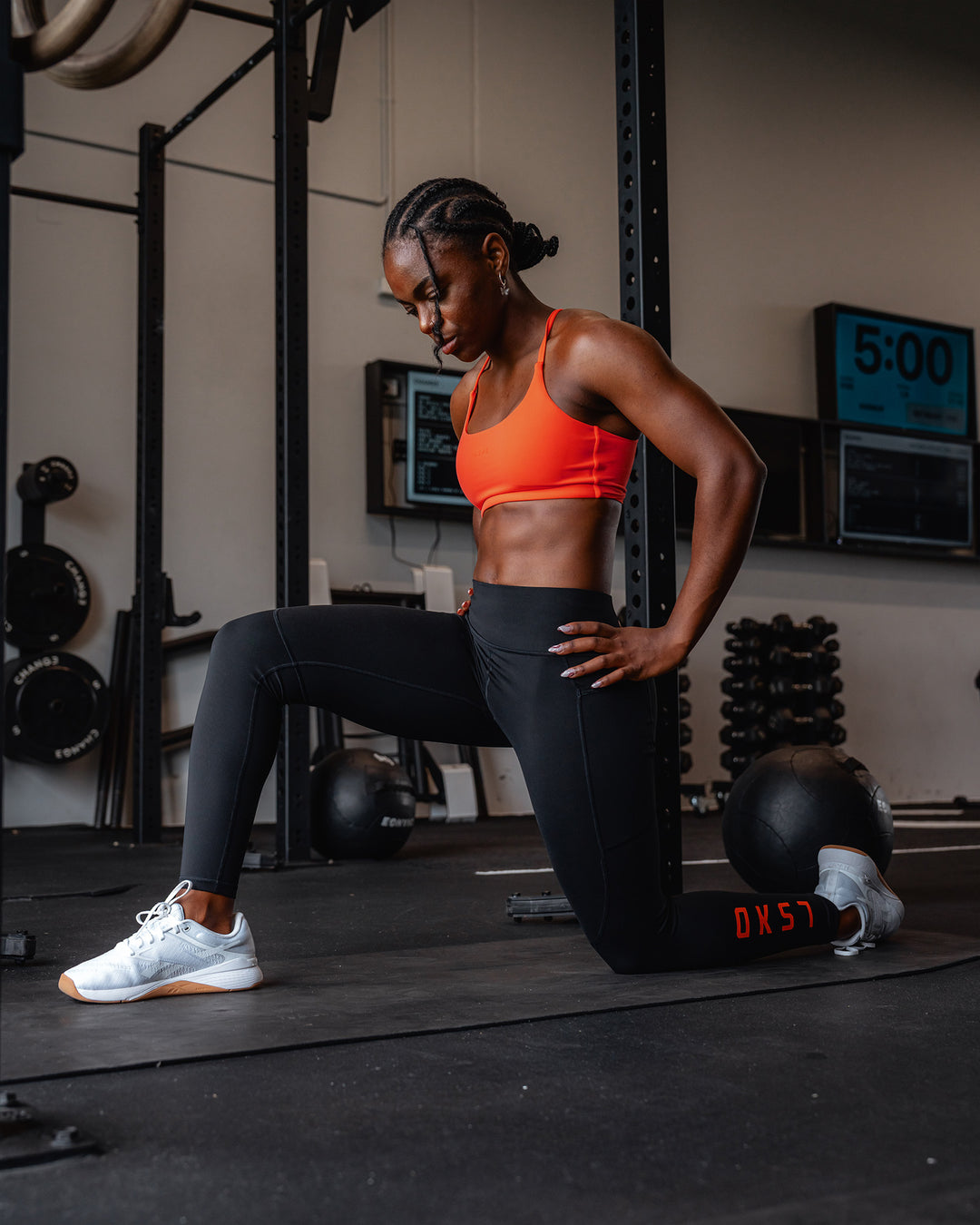 Woman wearing Twist Sports Bra - Ultra Orange | Model:Cebile | Size:S - view 2
