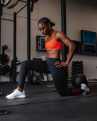 Woman wearing Twist Sports Bra - Ultra Orange | Model:Cebile | Size:S | Thumbnail Index: 1