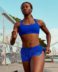 Woman wearing Velocity Sports Bra - Electric Indigo | Model:Naa | Size:S | Thumbnail Index: 0
