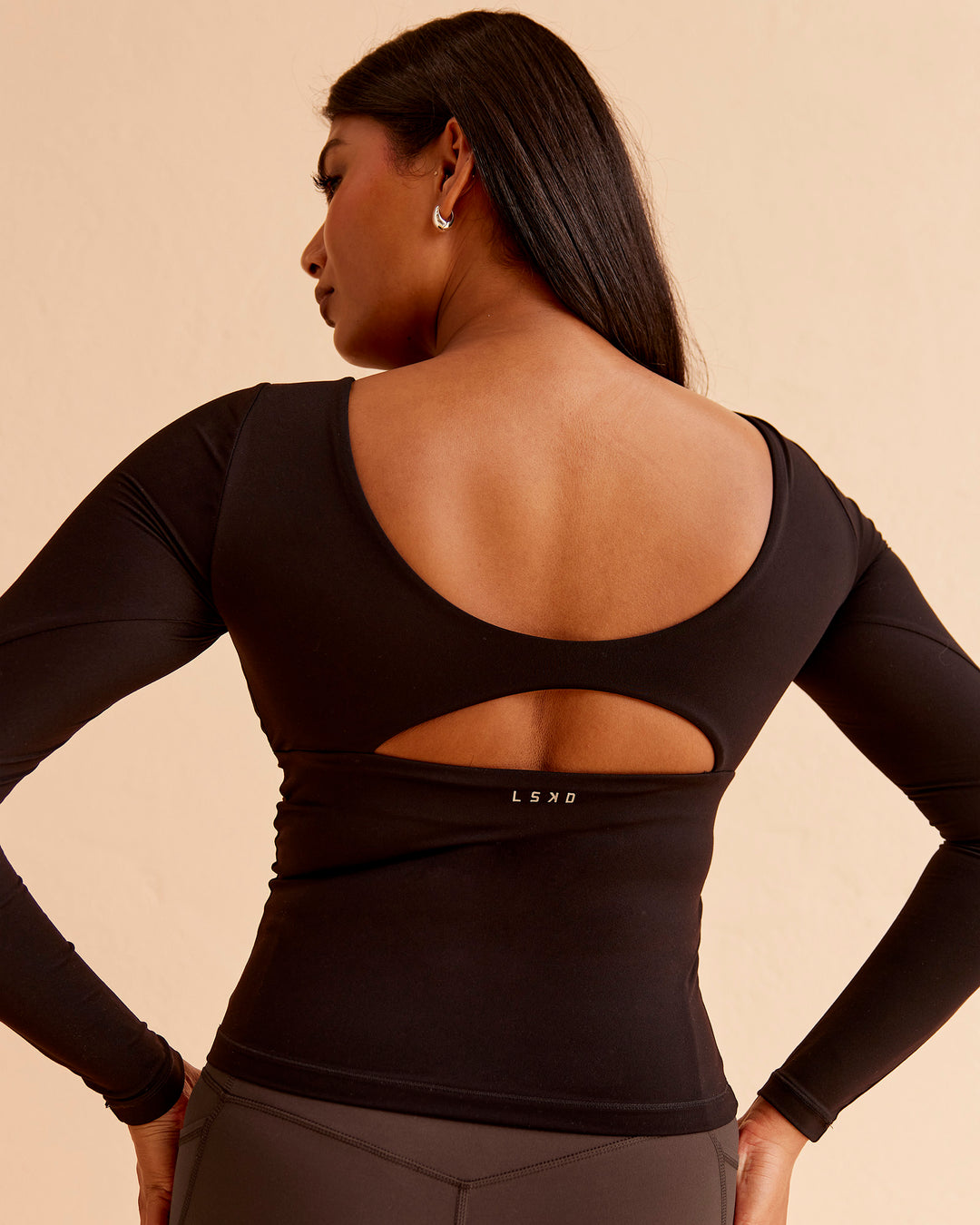 Woman wearing Vitality Long Sleeve Top - Black | Model:Nikki | Size:S - view 1