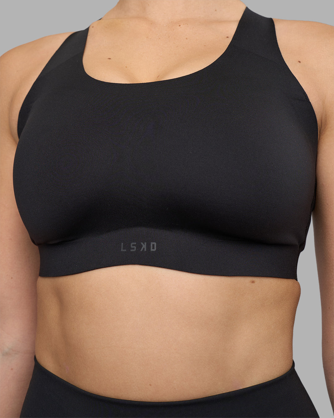 Woman wearing Stability Sports Bra - Black | Model:Amy | Size:S (D-E Cup) - view 7