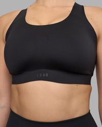 Woman wearing Stability Sports Bra - Black | Model:Amy | Size:S (D-E Cup) | Thumbnail Index: 6