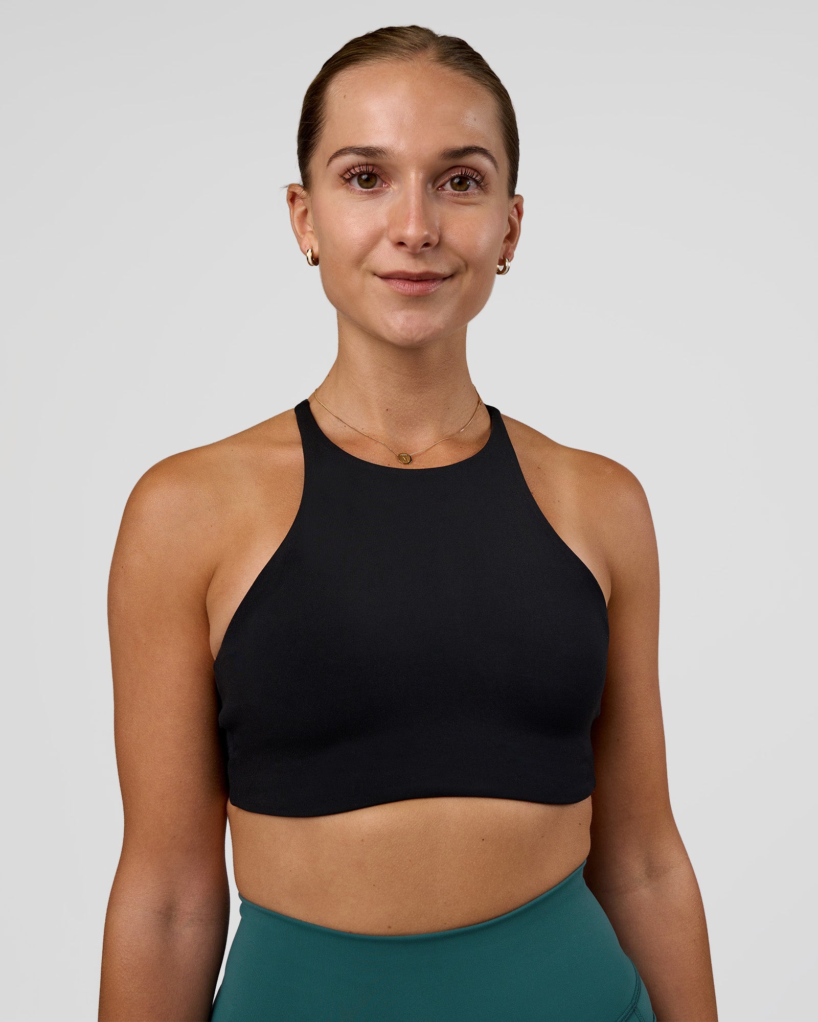Woman wearing AMRAP High Neck Sports Bra - Black | Model:Myrte | Size:S