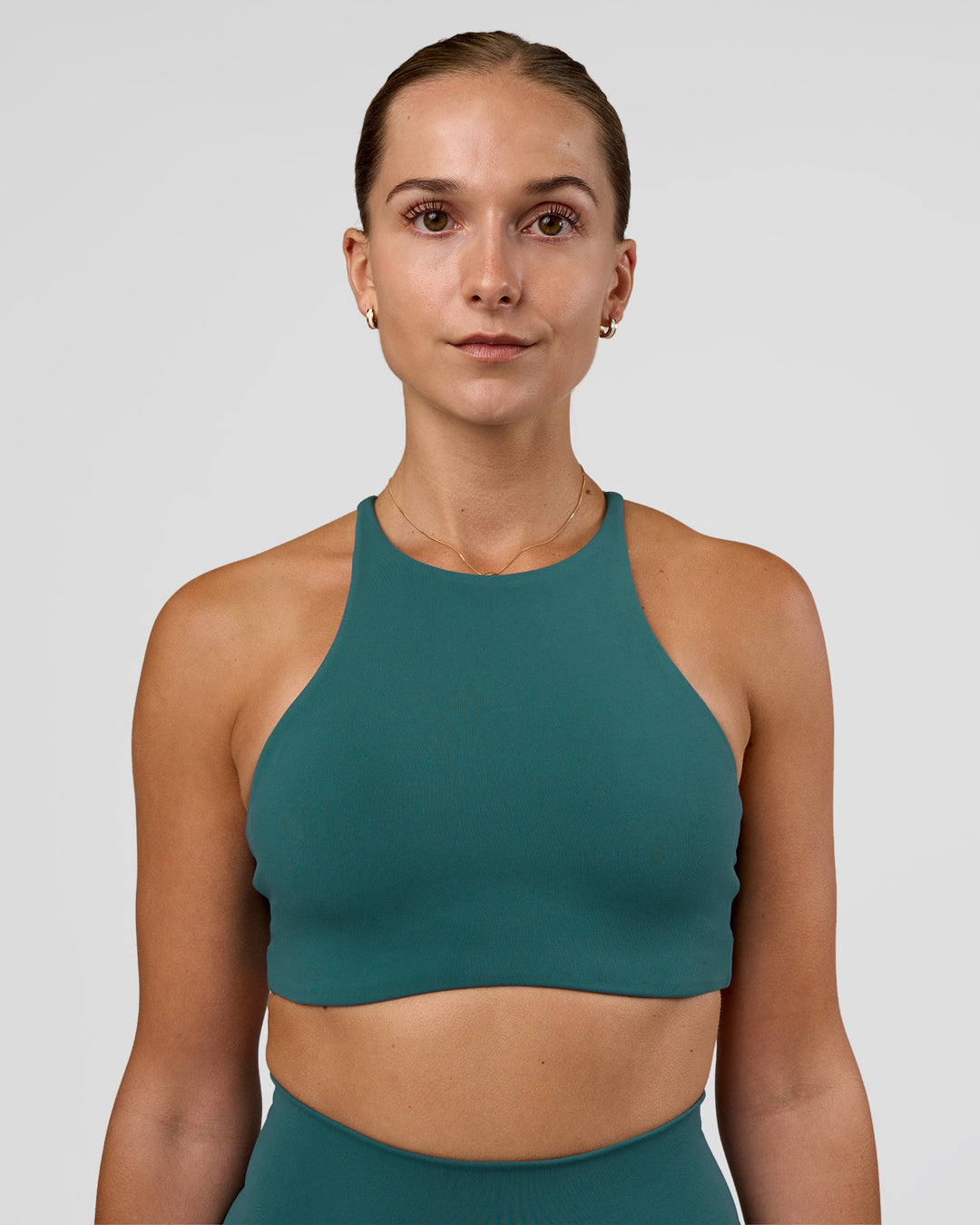 Woman wearing AMRAP High Neck Sports Bra - Transformative Teal | Model:Myrte | Size:S - view 1
