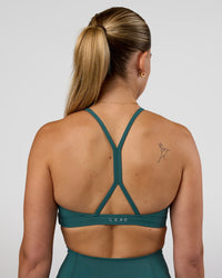 Woman wearing AMRAP High Neck Sports Bra - Transformative Teal | Model:Myrte | Size:S | Thumbnail Index: 1