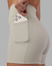Woman wearing Abs Fusion High-Rise 4" Short Pockets - Shale Beige | Model:Abbey | Size:S | Thumbnail Index: 2