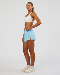 Woman wearing Accelerate 3" High-Rise Running Short - Baltic Sea-Off White | Model:Emelia | Size:S | Thumbnail Index: 2