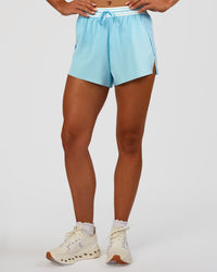 Woman wearing Accelerate 3" High-Rise Running Short - Baltic Sea-Off White | Set:true | Angle:front | Model:Emelia | Size:S | Thumbnail Index: 0