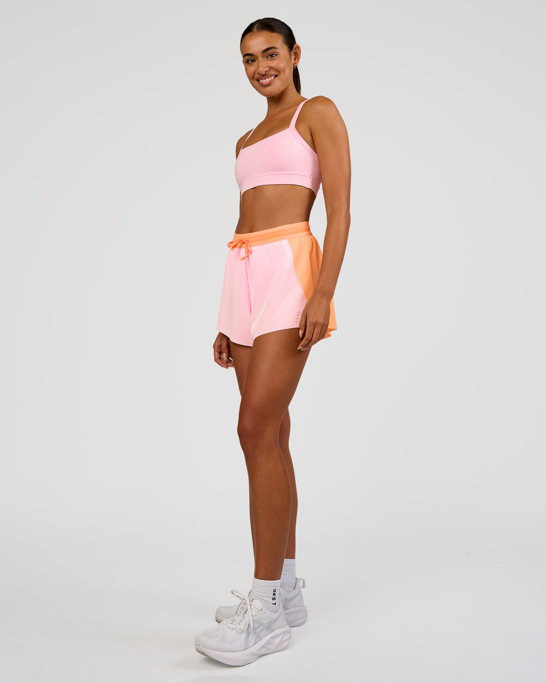 Woman wearing Accelerate 3" High-Rise Running Short - Cantaloupe-Marshmallow | Model:Ruby | Size:S - view 8