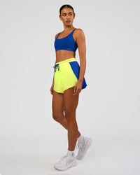 Woman wearing Accelerate 3" High-Rise Running Short - Electric Indigo-Lime Glo | Model:Ruby | Size:S | Thumbnail Index: 6