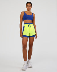 Woman wearing Accelerate 3" High-Rise Running Short - Electric Indigo-Lime Glo | Model:Ruby | Size:S | Thumbnail Index: 4