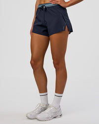 Woman wearing Accelerate 3" High-Rise Running Short - Future Navy-Baltic Sea | Set:true | Angle:side | Model:Evie | Size:S | Thumbnail Index: 2