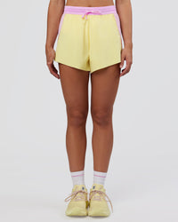 Woman wearing Accelerate 3" High-Rise Running Short - Marshmallow-Lemon | Set:true | Angle:front | Model:Grace | Size:S | Thumbnail Index: 5