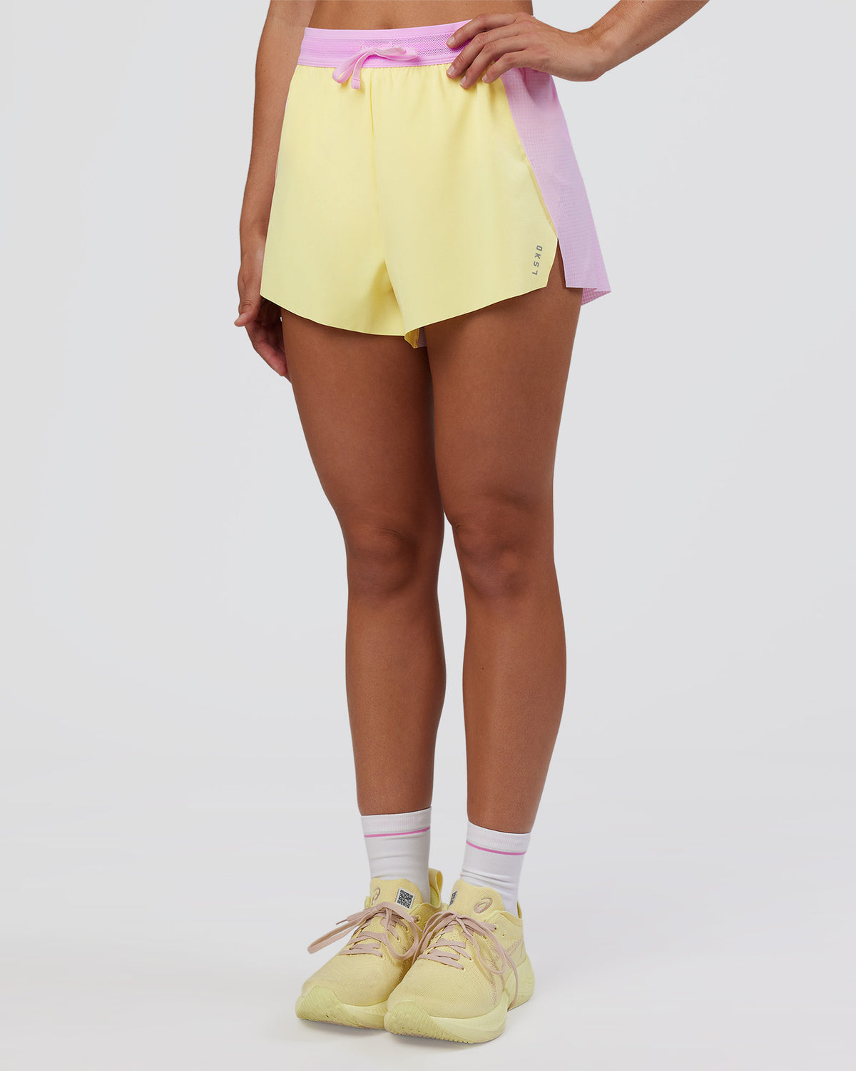 Woman wearing Accelerate 3" High-Rise Running Short - Marshmallow-Lemon | Set:true | Angle:side | Model:Grace | Size:S