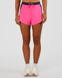 Woman wearing Accelerate 3" High-Rise Running Short - Midnight Plum-Sugar Plum | Set:true | Angle:front | Model:Emelia | Size:S | Thumbnail Index: 1