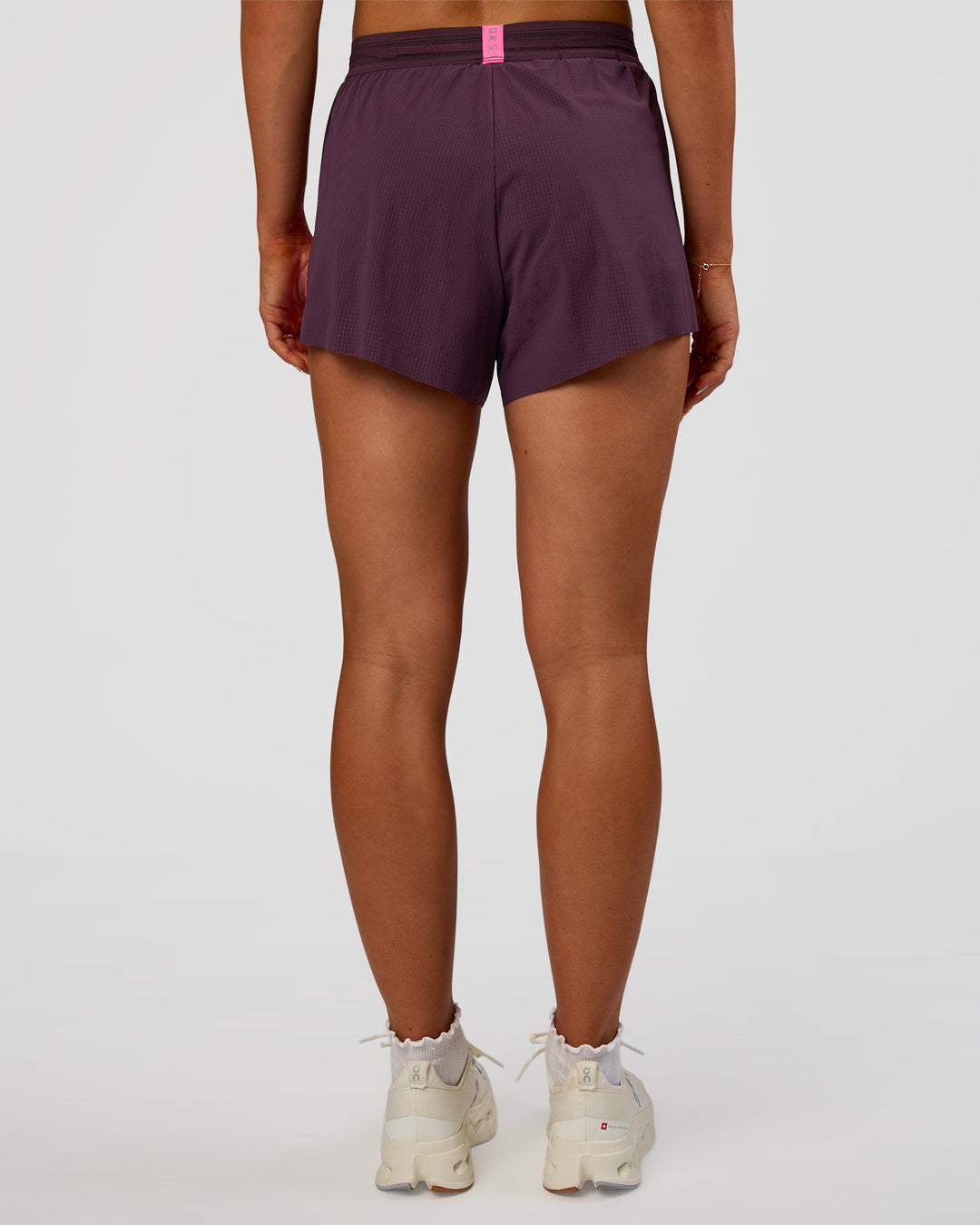 Woman wearing Accelerate 3" High-Rise Running Short - Midnight Plum-Sugar Plum | Set:true | Angle:back | Model:Emelia | Size:S - view 5